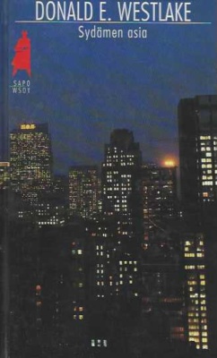 Sydämen asia -kirjan kannessa on öinen näkymä pilvenpiirtäjiin.