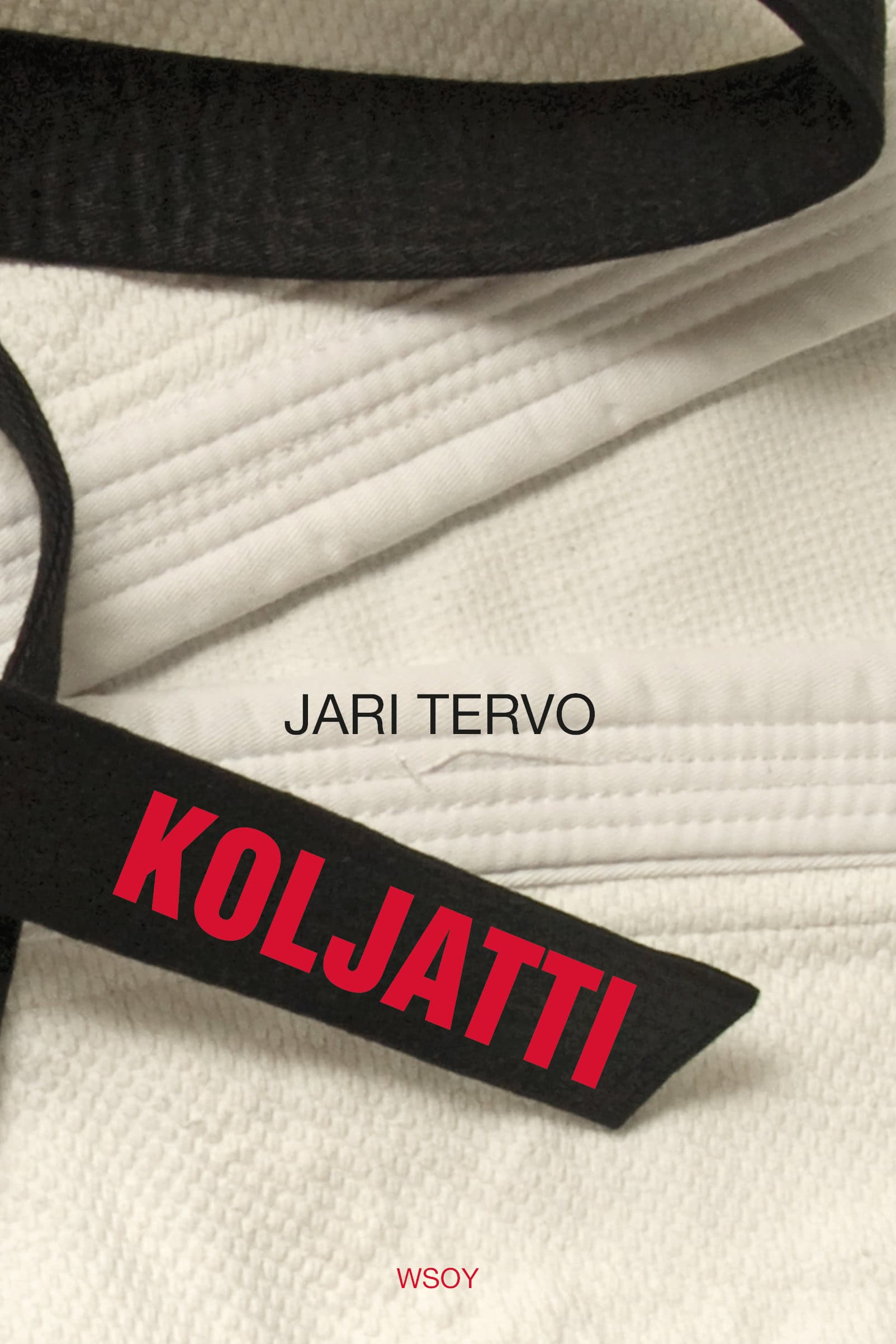 Koljatti-kirjan kannessa on lähikuva kankaasta, kenties gi-budoasusta, jonka päällä on musta vyö.